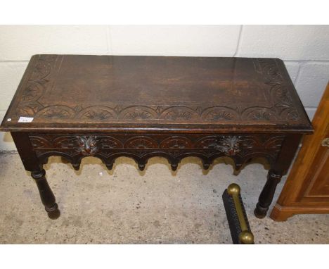 A small carved oak side table with lion mask handles (Item 5 on vendor list)