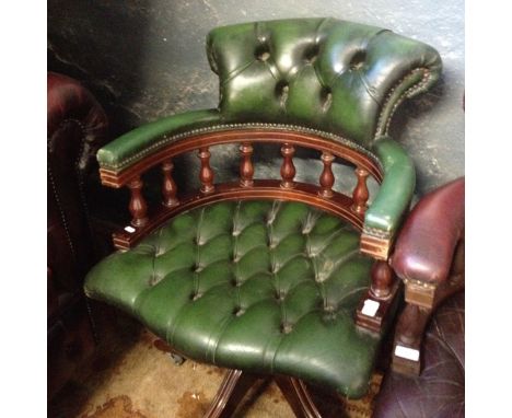 A Chesterfield green button leather swivel chair.