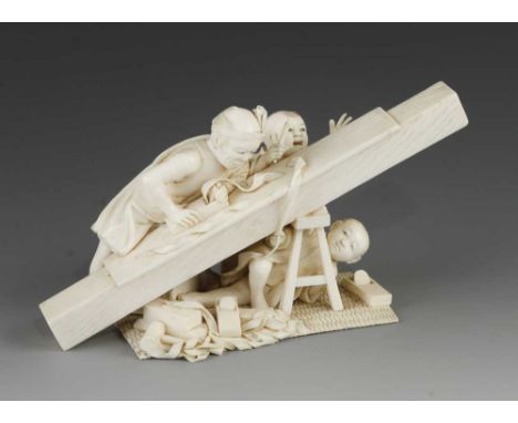 A very fine quality 19c Japanese ivory okimono of a carpenter planing his work with other tools scattered around and his two 