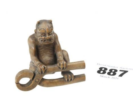 A 19c boxwood netsuke struggling with a large pair of pincers 2"h G++