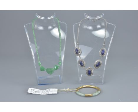 A 9ct gold clasp jade bangle together with a jade beaded necklace with hearts pendants and silver with lapis lazuli stone nec