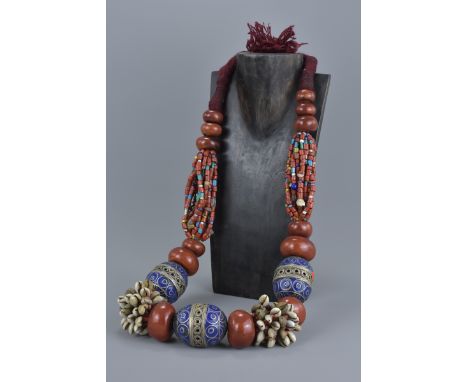 A large Moroccan beaded necklace with silver colour metal and enamel with coral coloured beads and shells.
