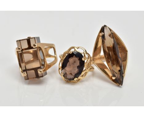 THREE 9CT GOLD SMOKEY QUARTZ DRESS RINGS, the first set with a rectangular cut Smokey quartz, openwork shoulders, hallmarked 