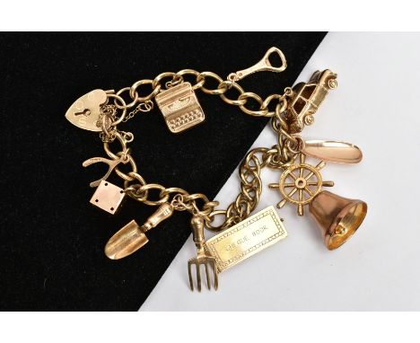 A 9CT GOLD CHARM BRACELET, suspending nine charms in  forms such as a bell, car, bottle opener, dice, cheque book, wishbone e