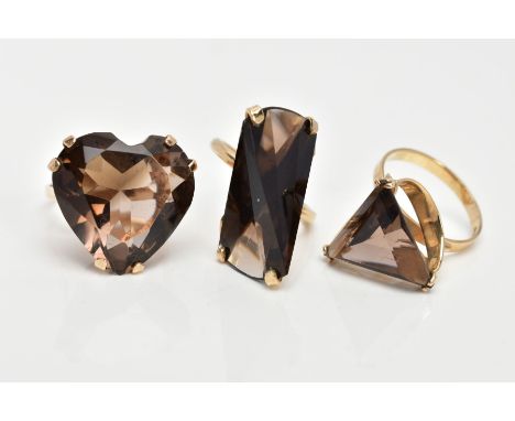 THREE 9CT GOLD SMOKEY QUARTZ DRESS RINGS, the first designed with a heart shaped Smokey quartz, plain polished band, openwork