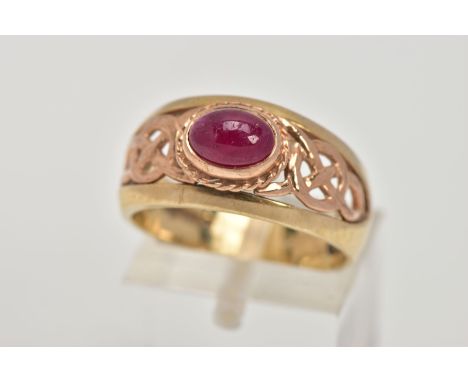 A 9CT GOLD 'CLOGAU' SIGNET RING, designed with a central oval ruby cabochon, collet mount with a rope twist surround, to the 