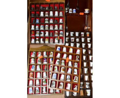 A BOX OF APPROXIMATELY ONE HUNDRED AND FORTY EIGHT THIMBLES IN WOODEN DISPLAY CASES, mostly ceramic with a small number of me