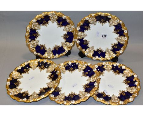 A SET OF FIVE EARLY 20TH CENTURY COALPORT DESSERT PLATES, wavy and moulded foliate gilt rims, blue borders with gilt and enam