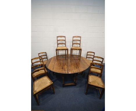 A GEORGIAN OAK OVAL GATE LEG TABLE, plank top, on turned supports united by a box stretcher together with a set of ten oak la