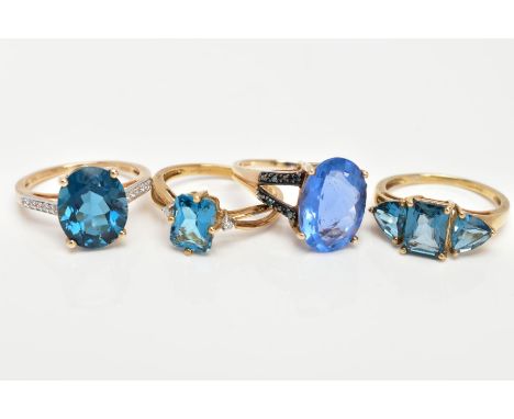 FOUR 9CT GOLD GEM SET DRESS RINGS, the first a three stone ring set with a rectangular cut blue topaz flanked with triangular