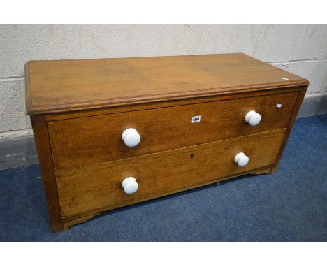 A LOW OAK CHEST OF TWO DRAWERS, with ceramic handles, width 100cm x depth 43cm x height 46cm