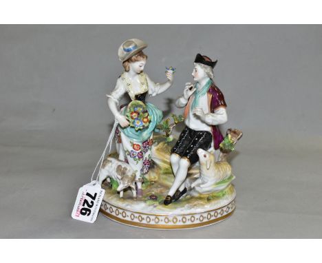 A VIENNA PORCELAIN FIGURE GROUP OF A SHEPHERD AND SHEPHERDESS in 18th Century costume, modelled with two sheep on an oval bas