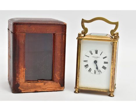 A BRASS CARRIAGE CLOCK WITH LEATHER CASE AND A KEY, the brass framed and glass panel clock, white dial signed 'S Smith &amp; 