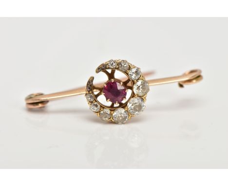 A YELLOW METAL, DIAMOND AND RUBY BROOCH, designed with a crescent, set with graduated old cut diamonds and rose cut diamonds,