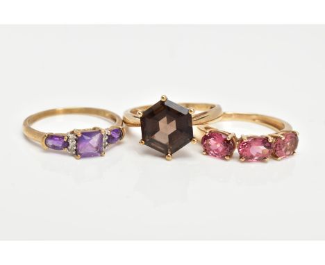 TWO 9CT GOLD GEM SET RINGS AND A YELLOW METAL AMETHYST AND DIAMOND RING, the first set with a hexagonal cut Smokey quartz, ha