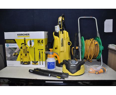 A KARCHER K4 PRESSURE WASHER with patio head, lance and pipe, 2 attachments, bottle of stone and paving cleaning fluid and or
