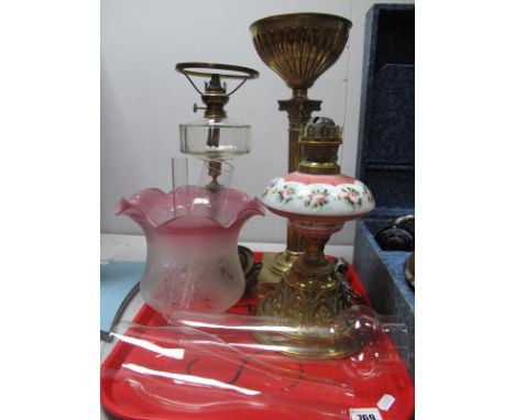 A Cast Brass Oil Lamp Base and Reservoir as a Corinthian Column, a further brass and porcelain oil lamp base, frosted pink sh