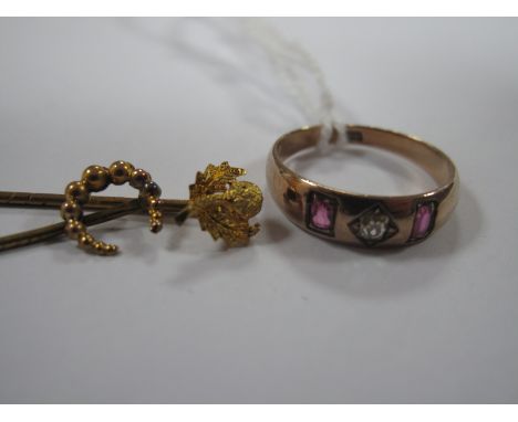 A Three Stone Ring, diamond set to the centre; together with two stick pins. (3)