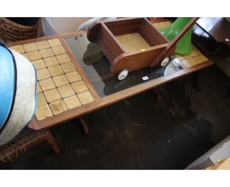 A teak and tile topped coffee table with glass insert