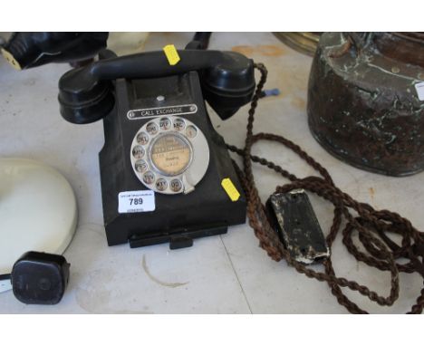 A Bakelite rotary dial telephone 
