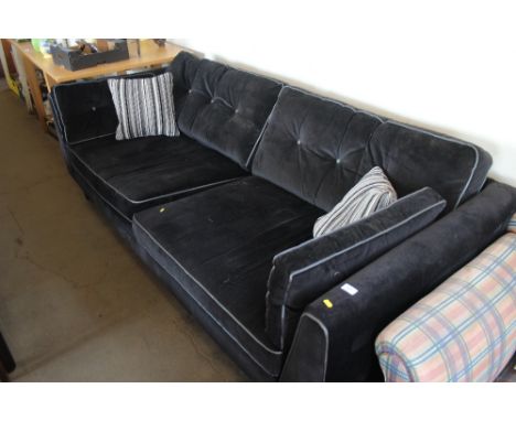 A large black velvet sofa