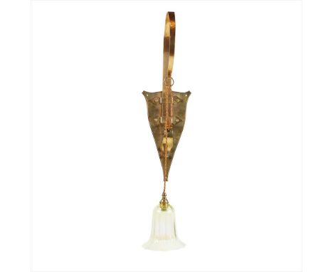 BIRMINGHAM GUILD OF HANDICRAFT ARTS &amp; CRAFTS BRASS WALL SCONCE, CIRCA 1900 with single curved bracket and shield backplat