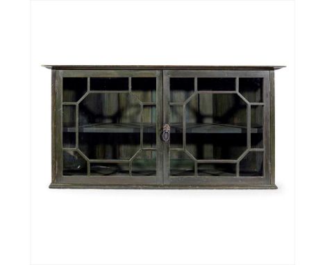 THE GUILD OF HANDICRAFT LTD. GREEN STAINED BEECH WALL CABINET, CIRCA 1900 the projecting cornice above twin glazed doors, enc