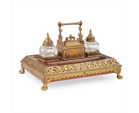 ENGLISH SCHOOL GOTHIC REVIVAL BRASS-MOUNTED OAK DESK STAND, CIRCA 1890 the central covered compartment with enamelled decorat