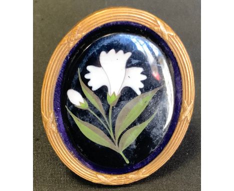 A 19th century Ashford Marble oval plaque, innset with a white flower, ribbed gilt metal easel frame, 6cm high, c.1850 