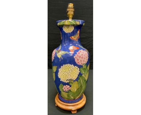 A contemporary Chinese baluster form lamp decorated with large  chrysanthemum flower heads and butterflies on a blue ground, 