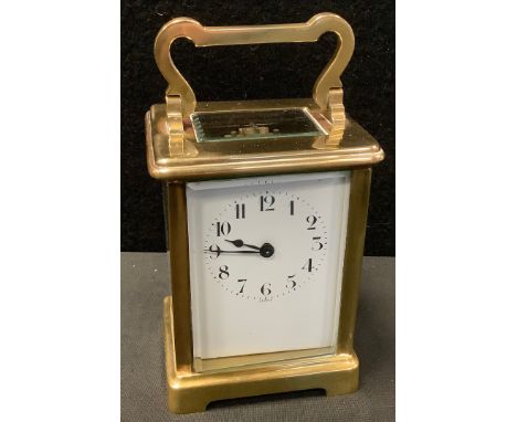 An early 20th century French carriage clock, white dial, folding handle, 14.5cm high, with key. 