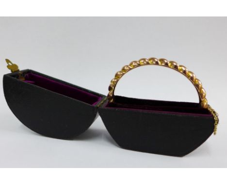 Victorian 9ct gold bangle, with gadrooned pattern and hinged clasp, original black leather case