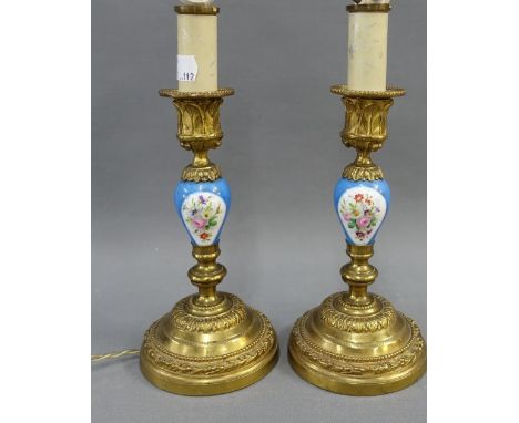 A pair of French candlesticks, converted to table lamps with Serves style porcelain knop stems,  36cm high (2) 