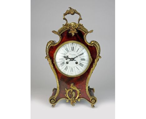 An early 20th century Louis XV style tortoiseshell veneered and gilt metal mantel clock, the 5½ inch convex enamel dial signe