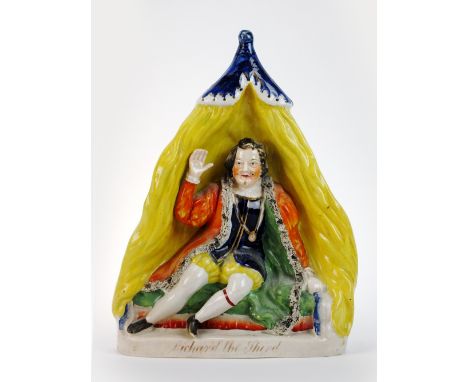 A 19th century Victorian Staffordshire figure, modelled as Garrick playing Richard the Third, seated in a yellow tent, titled
