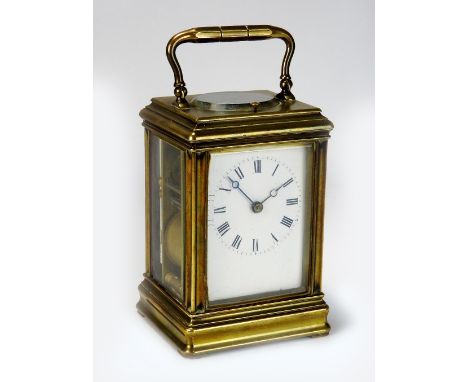 A late Victorian brass gorge cased repeating carriage clock, the 2½ inch enamel dial with ring of Roman numerals, the eight d
