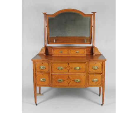 A late 19th / early 20th century satinwood and marquetry bedroom suite comprising of a break-front combination wardrobe with 