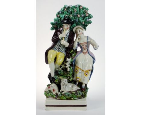A Staffordshire group of a Shepherd and Shepherdess with bocage behind, attributed to Dudson, circa 1815-20, the two figures 