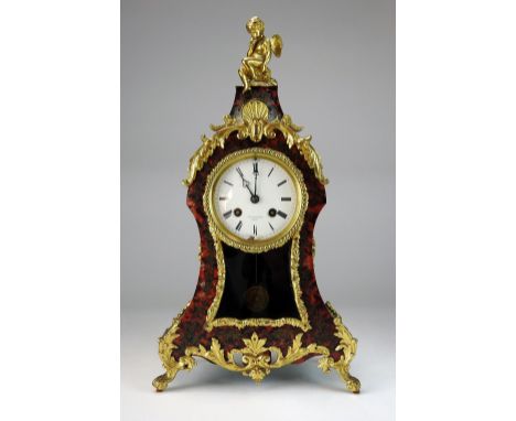 A late 19th century Louis XV style tortoiseshell brass inlaid mantel clock with gilt metal mounts, the 3½ inch enamel dial si