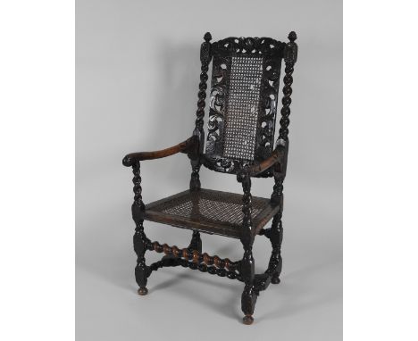 A William and Mary walnut open armchair, the back with woven cane central panel between pieced scrolling leaves and barley tw