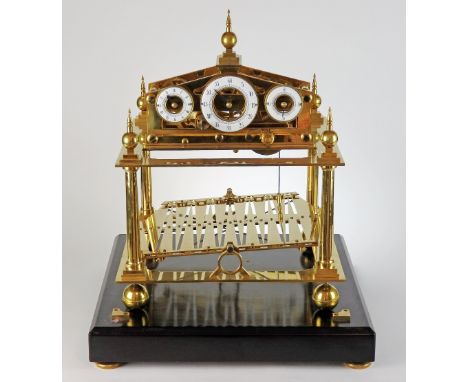 A 20th century gilt brass 'Congreve' type rolling ball clock, the three enamel Arabic chapter rings showing hours, minutes an