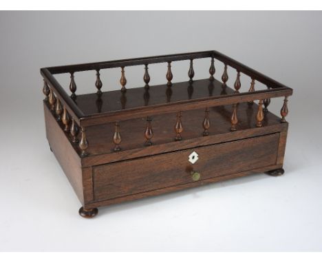 A mid 19th century rosewood desk stand, of rectangular form with galleried top, over a single drawer opening to reveal a hing