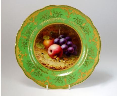 A Coalport fruit-painted cabinet plate decorated by F. H. Chivers, late 19th/early 20th century, the central panel of fruit a