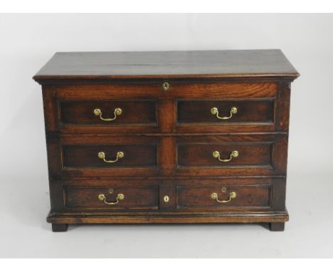 A late 17th / early 18th century joined oak mule chest, the hinged lid over two rows of short false drawers above two short d