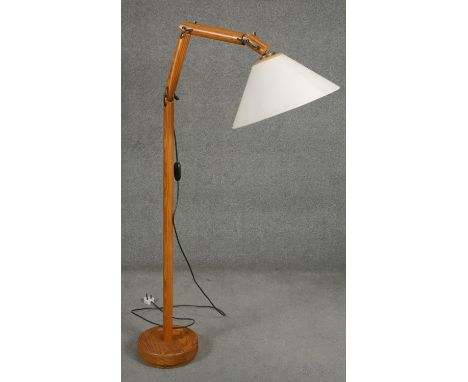 A floor standing full height reading lamp on an articulated adjustable column. H.160cm 