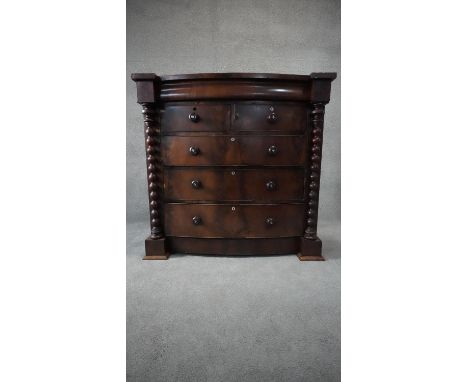 A Victorian mahogany bowfronted chest of two short above three long drawers flanked by bobbin turned pilasters on plinth base