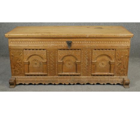 A late 19th century Continental carved light oak coffer with twin carrying handles on shaped supports. H.57 W.130 D.49cm 