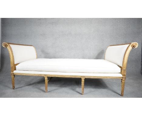 A Louis XVI giltwood daybed in the style of JEAN-BAPTISTE SENE. With fitted cushion, carved and gilded wood, flared sides, re