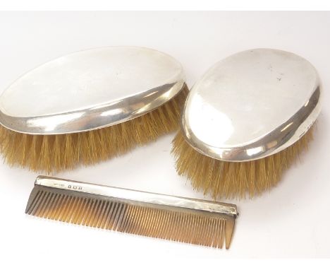 Pair of silver hair brushes and a comb.