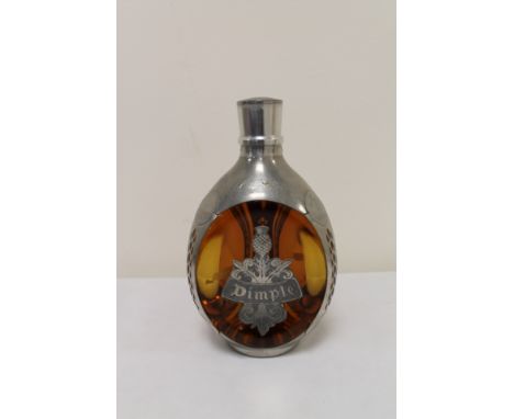 Bottle of Haig Dimple Scotch whisky 12 year old in bottle with pewter mounts.